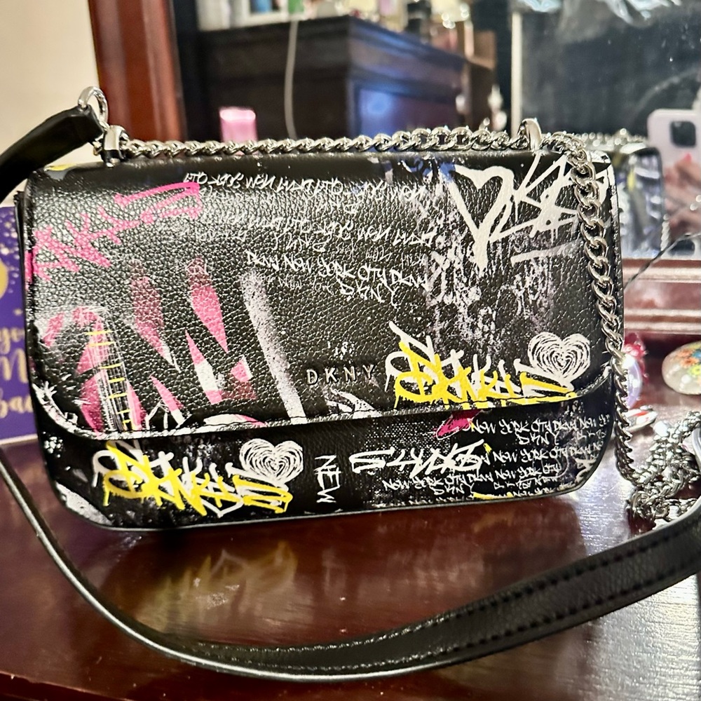 DKNY crossbody purse. Black with graffiti on front